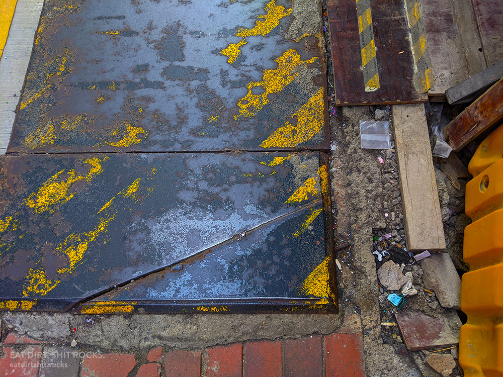 A complicated bit of sidewalk at the edge of a construction site in Causeway Bay.